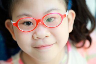 Porträtt på en liten flicka från Sydkorea med röda glasögon